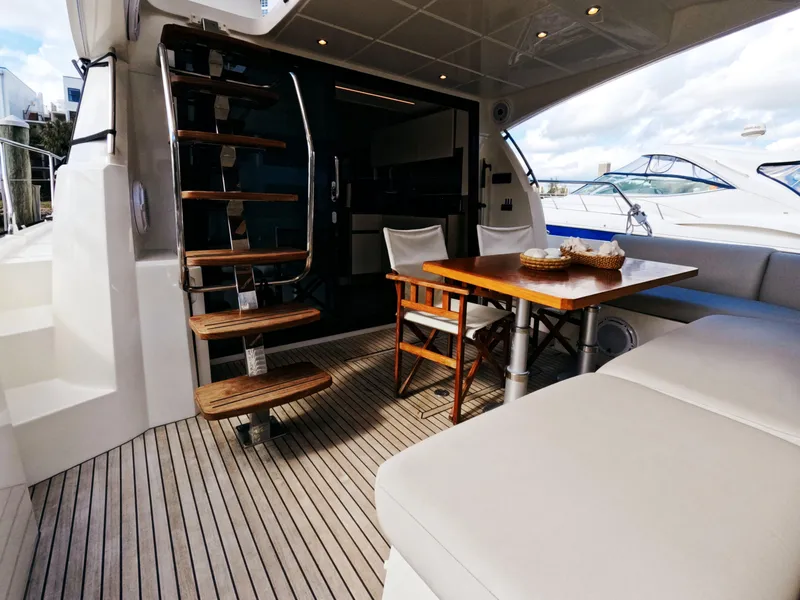 Slide: The Image of Prestige 460 yacht interior, 2020 model, featuring elegant seating and wooden table. - 15