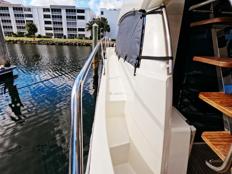 Slide: The Image of Side view of a 2020 Prestige 460 yacht docked near waterfront buildings. - 16