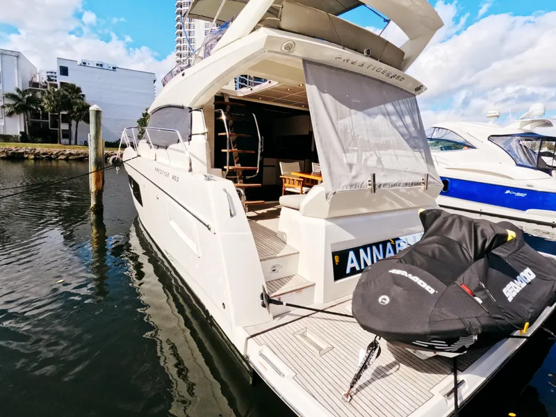 Slide: The Image of 2020 Prestige 460 yacht docked, featuring spacious deck and modern design. - 48