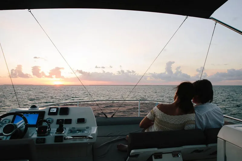 Slide: The Image of Couple enjoying sunset on a 2020 Prestige 460 yacht at sea. - 6