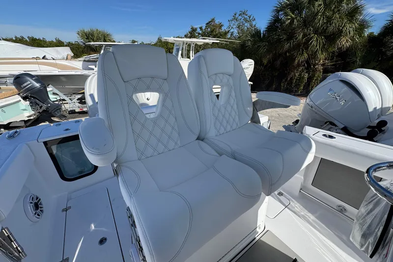 Slide: The Image of 2026 Sportsman Open 262 Center Console boat with luxurious white seating. - 11