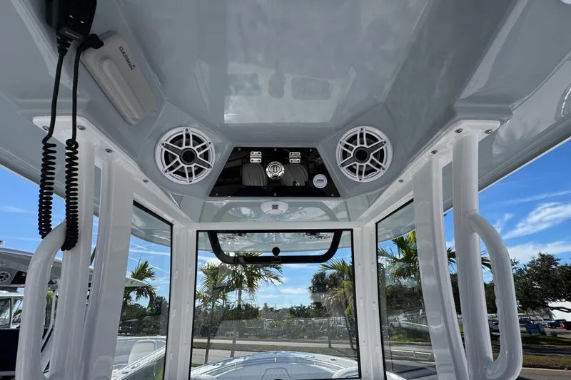 Slide: The Image of 2026 Sportsman Open 262 Center Console interior with speakers and electronics, under a clear blue sky. - 13