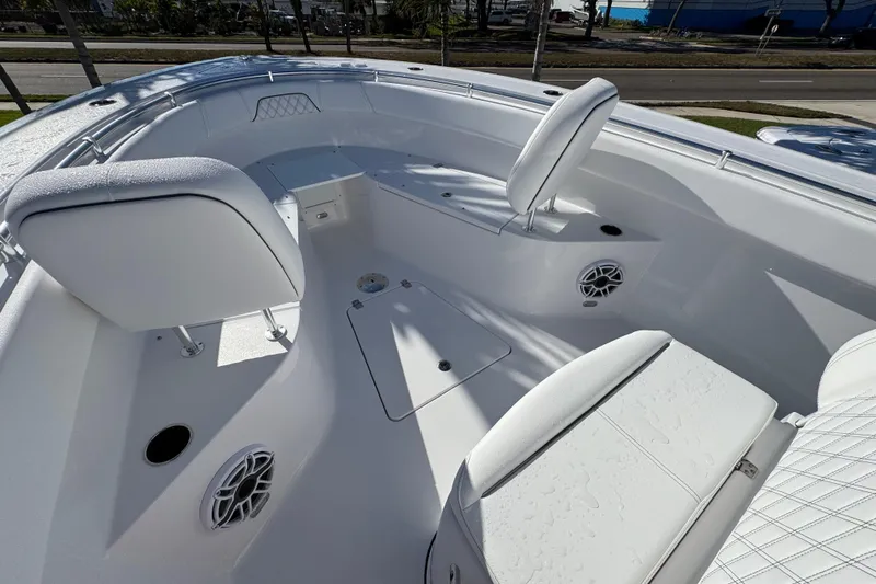 Slide: The Image of 2026 Sportsman Open 262 Center Console boat interior with white seating and speakers. - 15