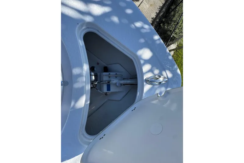 Slide: The Image of Open storage compartment on 2026 Sportsman Open 262 Center Console boat. - 18