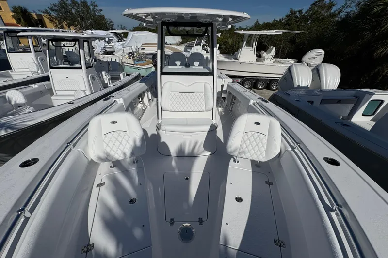 Slide: The Image of 2026 Sportsman Open 262 Center Console boat with white seating and sleek design. - 19