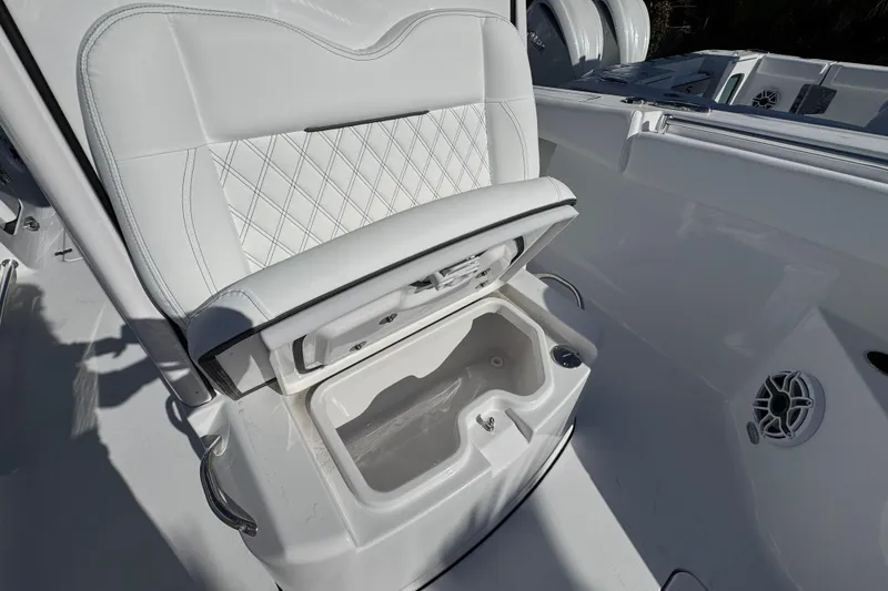 Slide: The Image of 2026 Sportsman Open 262 Center Console boat seat with storage compartment open. - 20