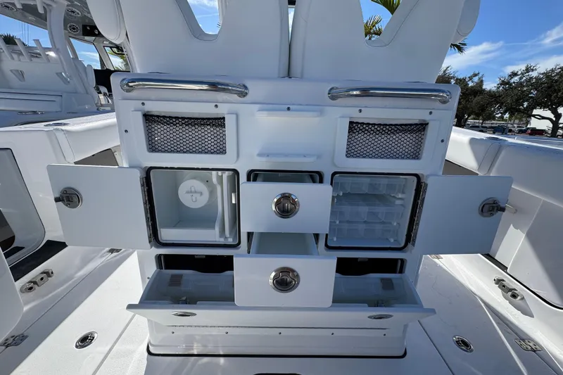 Slide: The Image of 2026 Sportsman Open 262 Center Console boat interior with open storage compartments and drawers. - 7