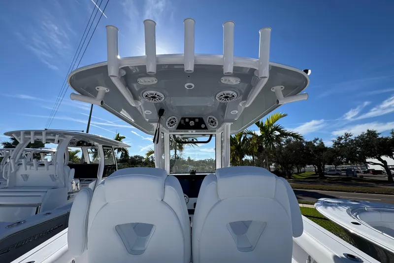 Slide: The Image of 2026 Sportsman Open 262 Center Console boat interior with rod holders and seating. - 8