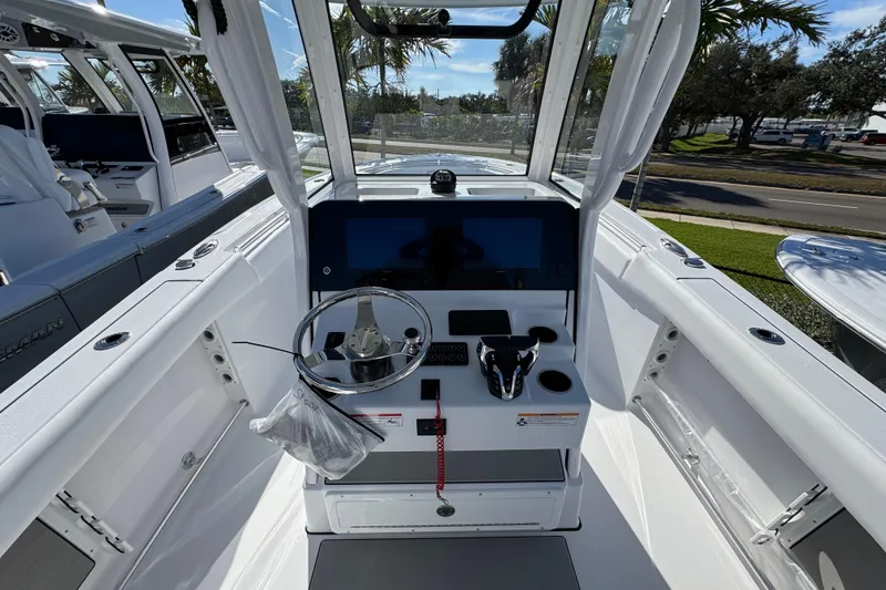 Slide: The Image of 2026 Sportsman Open 262 Center Console boat interior with steering wheel and control panel. - 9