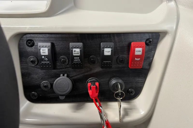 Slide: The Image of Control panel of 2026 SunChaser Vista 16 Fish boat with switches and ignition keys. - 10