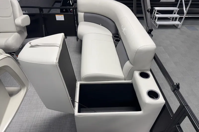 Slide: The Image of 2026 SunChaser Vista 16 Fish boat interior with white seating and storage compartment. - 12