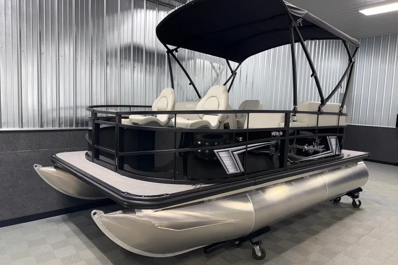 Slide: The Image of 2026 SunChaser Vista 16 Fish pontoon boat in showroom, featuring sleek design and comfortable seating. - 18