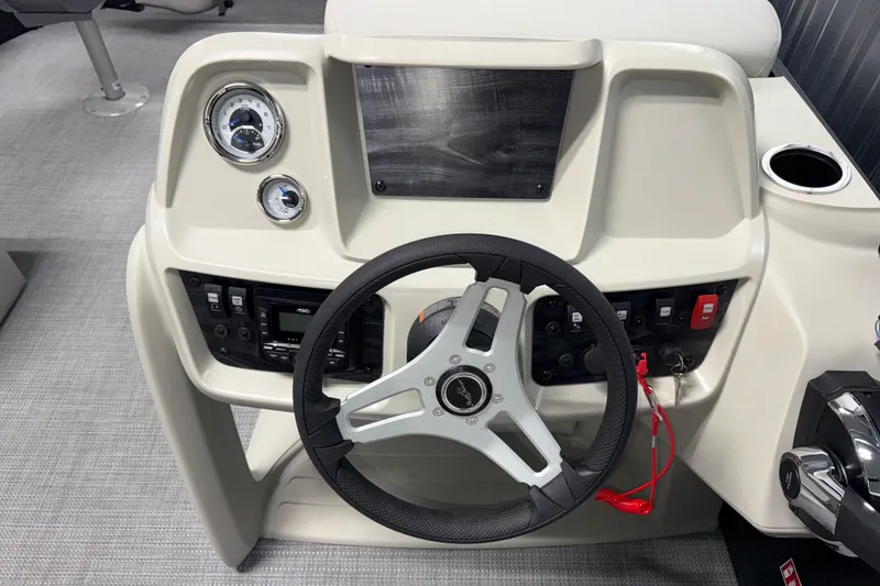 Slide: The Image of 2026 SunChaser Vista 16 Fish boat dashboard with steering wheel and control panel. - 8