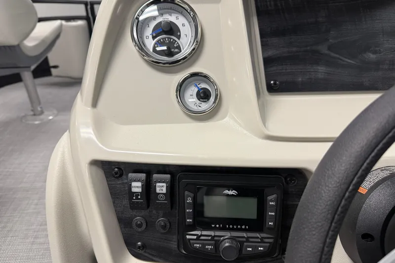 Slide: The Image of Dashboard of 2026 SunChaser Vista 16 Fish boat with gauges and stereo controls. - 9