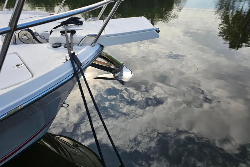 Slide: The Image of 2022 Cuwater C-32-CB boat anchored on calm reflective water. - 10