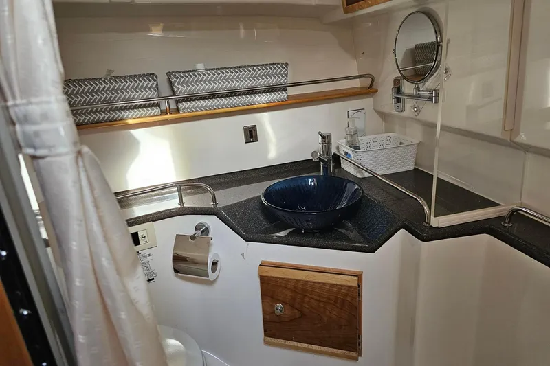 Slide: The Image of Compact bathroom in 2022 Cuwater C-32-CB boat with modern sink and mirror. - 20