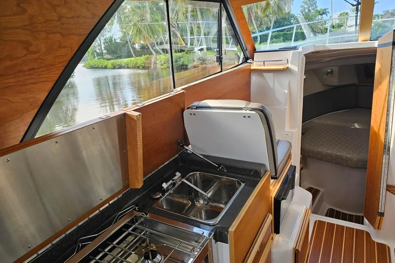 Slide: The Image of Interior of 2022 Cuwater C-32-CB boat with kitchenette and cozy cabin. - 27