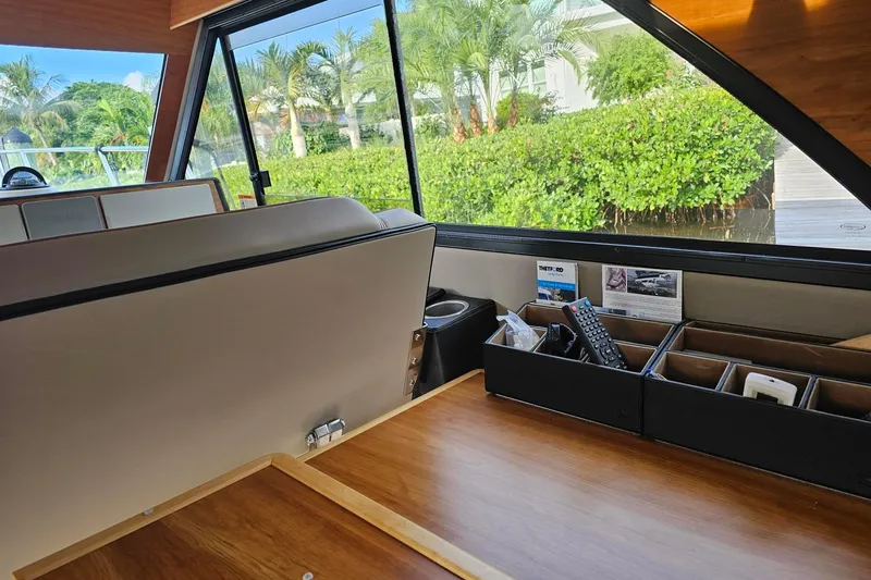 Slide: The Image of Interior of 2022 Cuwater C-32-CB boat with organized storage and scenic window view. - 28