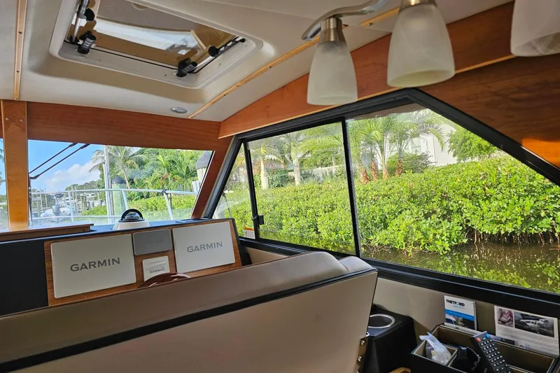 Slide: The Image of Interior of 2022 Cuwater C-32-CB boat with Garmin navigation system and scenic view. - 29