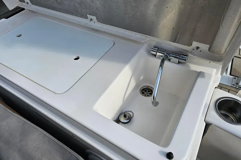 Slide: The Image of Boat sink and counter on 2022 Cuwater C-32-CB, featuring chrome faucet and drain. - 39