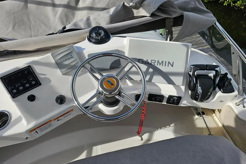 Slide: The Image of Cockpit of 2022 Cuwater C-32-CB boat with Garmin navigation system and Yamaha steering wheel. - 42