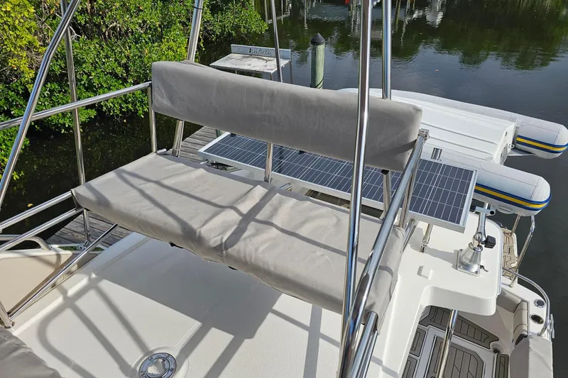 Slide: The Image of 2022 Cuwater C-32-CB boat with solar panels and cushioned seating by the water. - 45