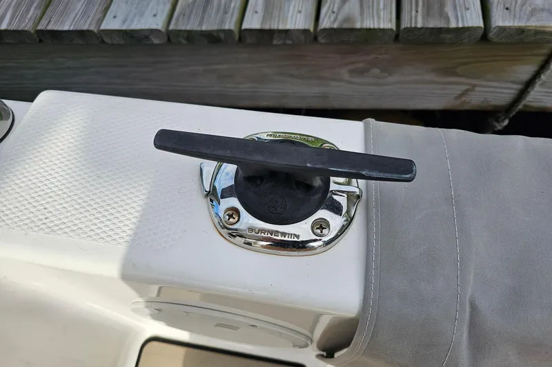 Slide: The Image of Boat cleat on a 2022 Cuwater C-32-CB, secured with a gray cover. - 47