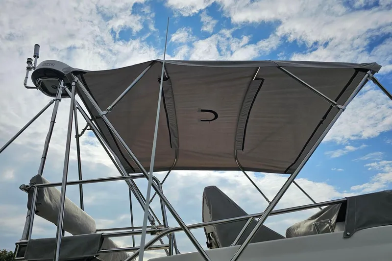 Slide: The Image of Cuwater C-32-CB boat canopy with metal frame against a cloudy sky, 2022 model. - 48