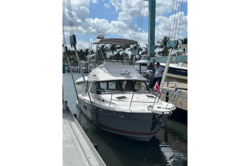 Slide: The Image of 2022 Cuwater C-32-CB boat docked at marina under cloudy sky. - 50