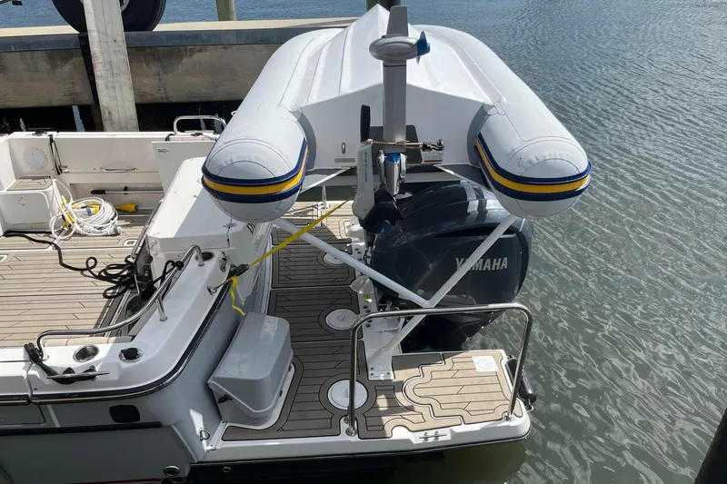 Slide: The Image of Inflatable boat on Cuwater C-32-CB, 2022 model, docked with Yamaha engine. - 52
