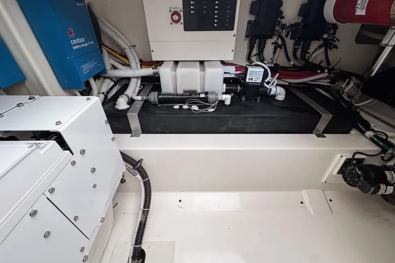 Slide: The Image of Engine compartment of 2022 Tiara Yachts 43 LS, showcasing mechanical components and wiring. - 23