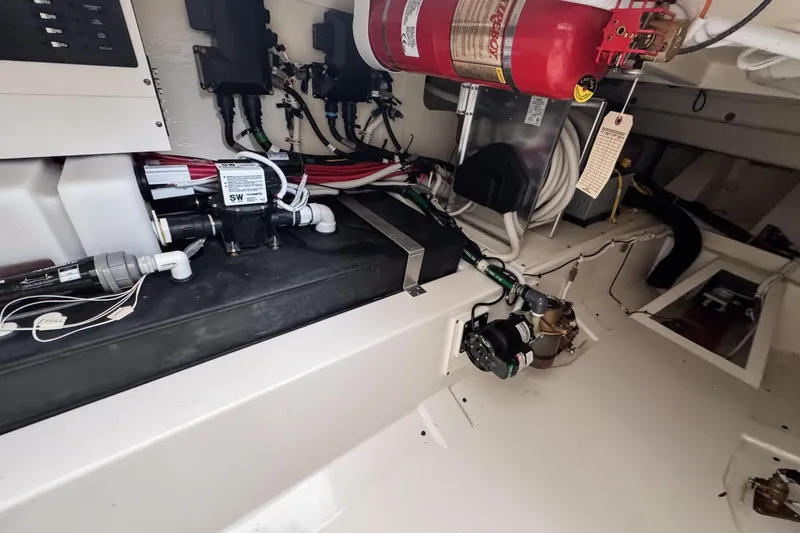 Slide: The Image of Engine room of 2022 Tiara Yachts 43 LS, featuring fire extinguisher and electrical components. - 24
