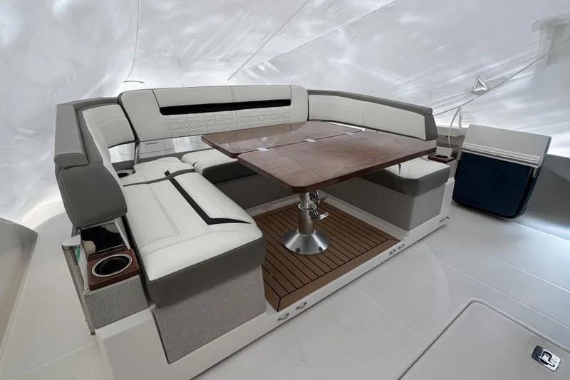 Slide: The Image of Luxurious seating area on 2022 Tiara Yachts 43 LS with elegant wood table. - 4