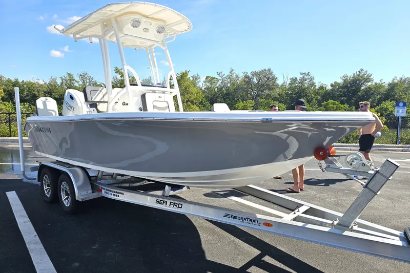The Image of 2025 Sea Pro 202 Center Console boat on trailer, parked outdoors. - 0