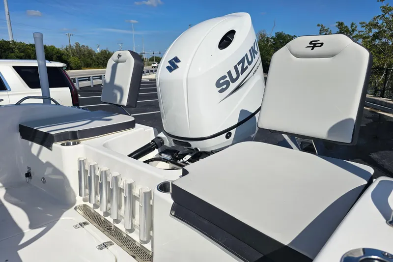 Slide: The Image of 2025 Sea Pro 202 Center Console boat with Suzuki outboard motor, parked on a trailer. - 12