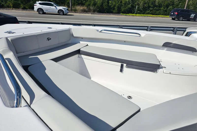 Slide: The Image of 2025 Sea Pro 202 Center Console boat with Suzuki outboard motor, parked outdoors. - 14