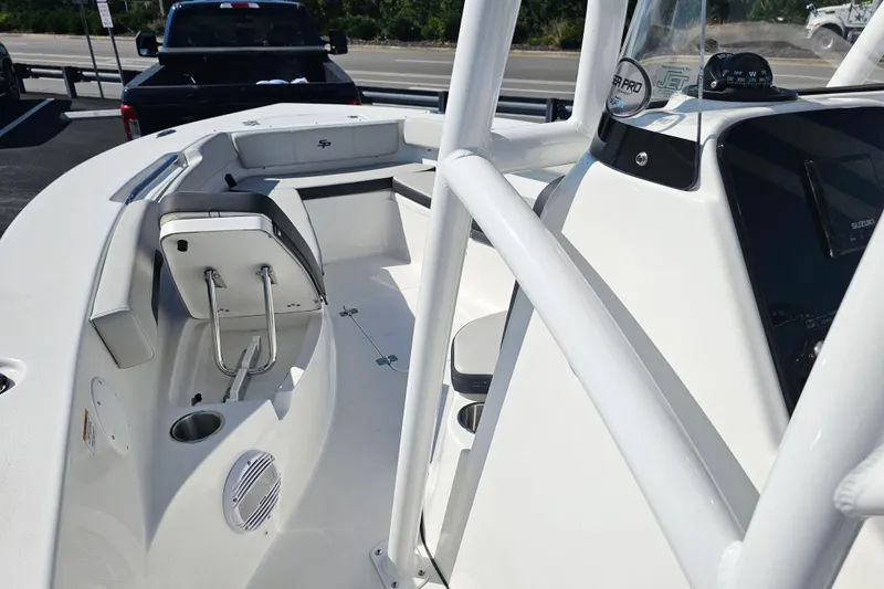 Slide: The Image of 2025 Sea Pro 202 Center Console boat interior with cushioned seating and storage. - 19