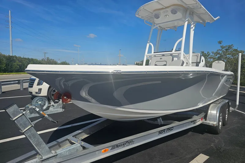Slide: The Image of 2025 Sea Pro 202 Center Console boat on trailer, parked outdoors. - 2