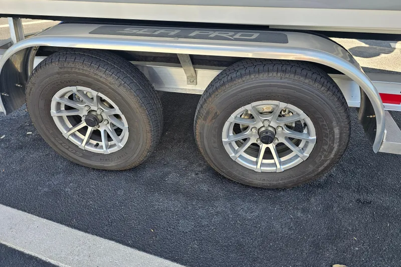 Slide: The Image of 2025 Sea Pro 202 Center Console boat with Suzuki outboard engine on trailer. - 9