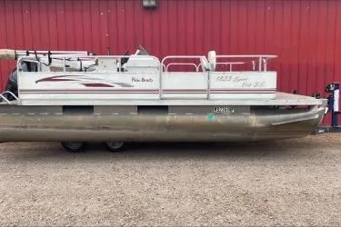 The Image of 2009 Palm Beach Sport Fish 1823 SE pontoon boat parked on gravel. - 1