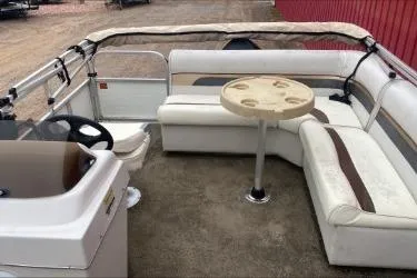 Slide: The Image of 2009 Palm Beach Sport Fish 1823 SE boat interior with seating and table. - 2