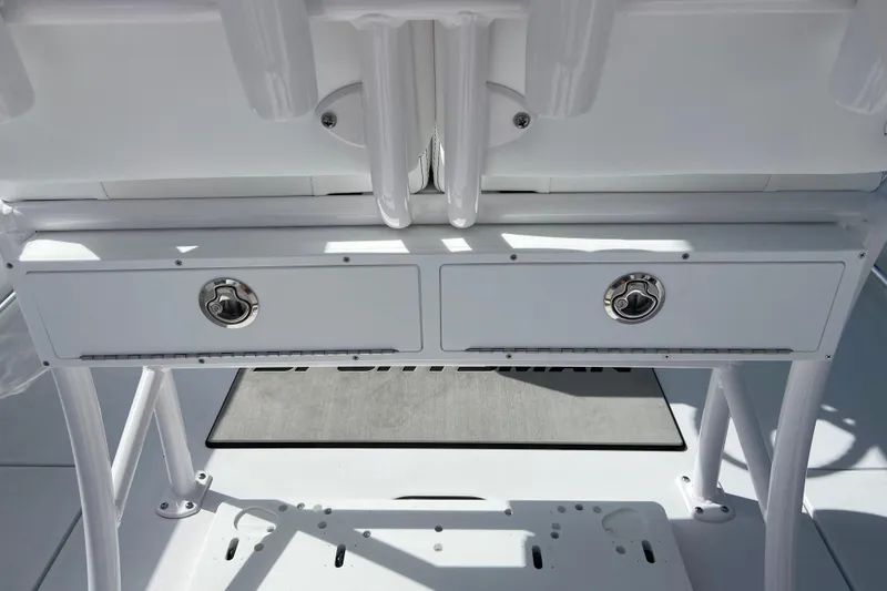 Slide: The Image of 2026 Sportsman Open 252 Center Console storage compartments with sleek design and secure latches. - 16