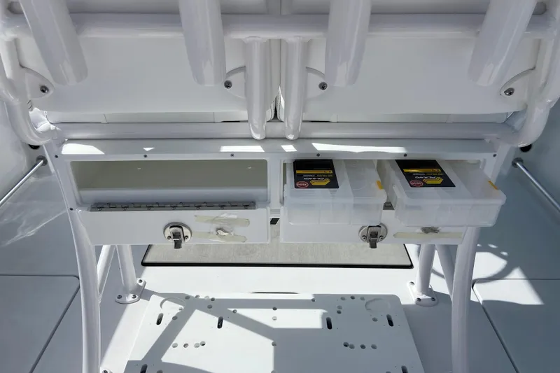 Slide: The Image of 2026 Sportsman Open 252 Center Console storage compartments with tackle boxes. - 17