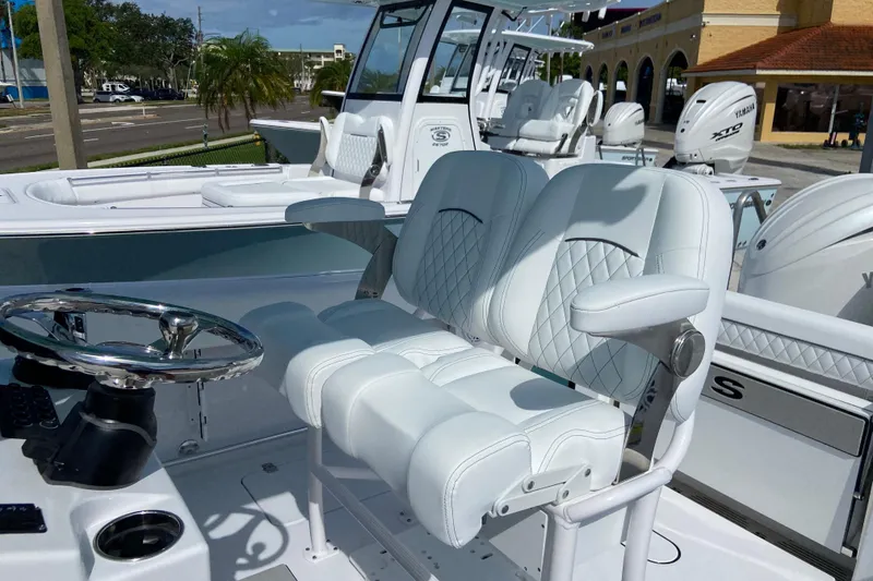Slide: The Image of 2026 Sportsman Open 252 Center Console boat with luxurious seating and modern steering wheel. - 20