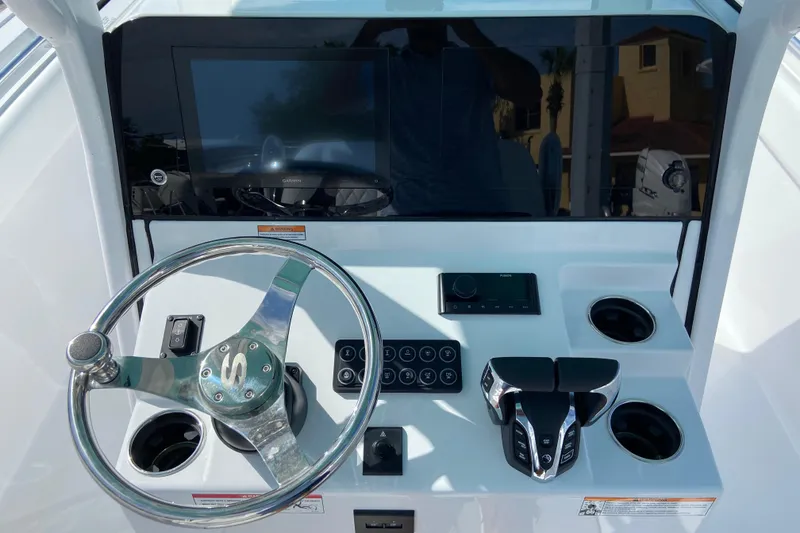 Slide: The Image of 2026 Sportsman Open 252 Center Console dashboard with steering wheel and electronic controls. - 24