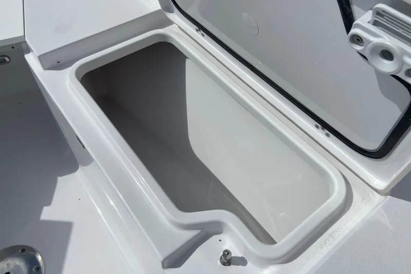 Slide: The Image of Open storage compartment on 2026 Sportsman Open 252 Center Console boat. - 32