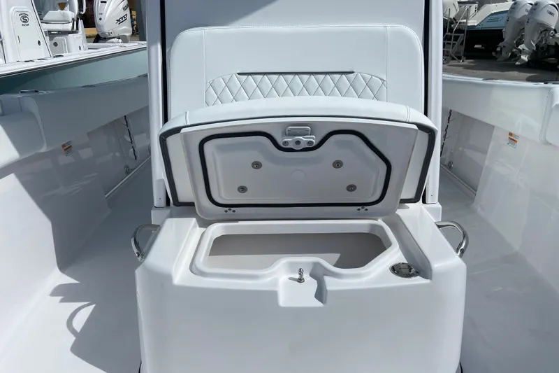 Slide: The Image of 2026 Sportsman Open 252 Center Console boat with open storage compartment and sleek white interior. - 39