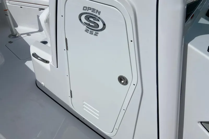 Slide: The Image of 2026 Sportsman Open 252 Center Console boat door detail in bright sunlight. - 40