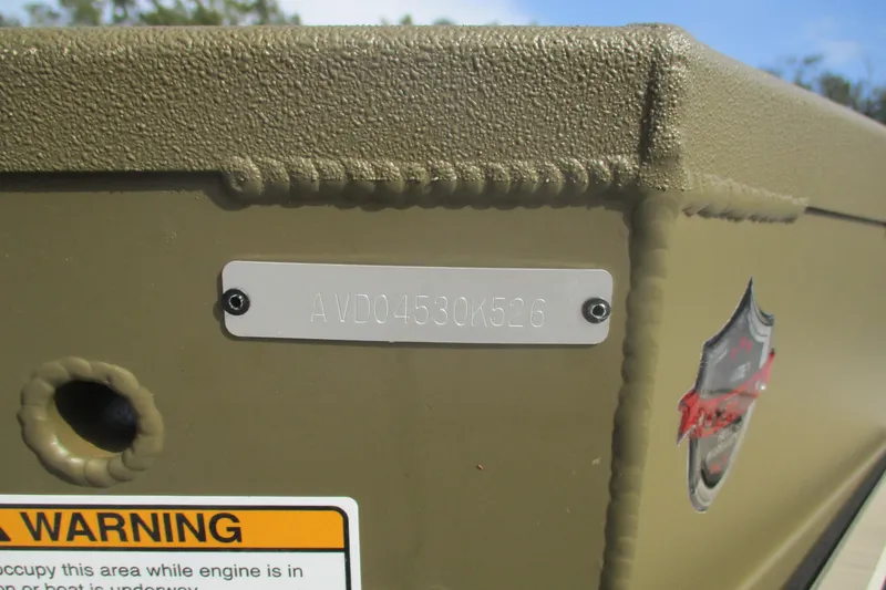 Slide: The Image of 2026 Avid 16 Commander boat hull identification number and warning label. - 13