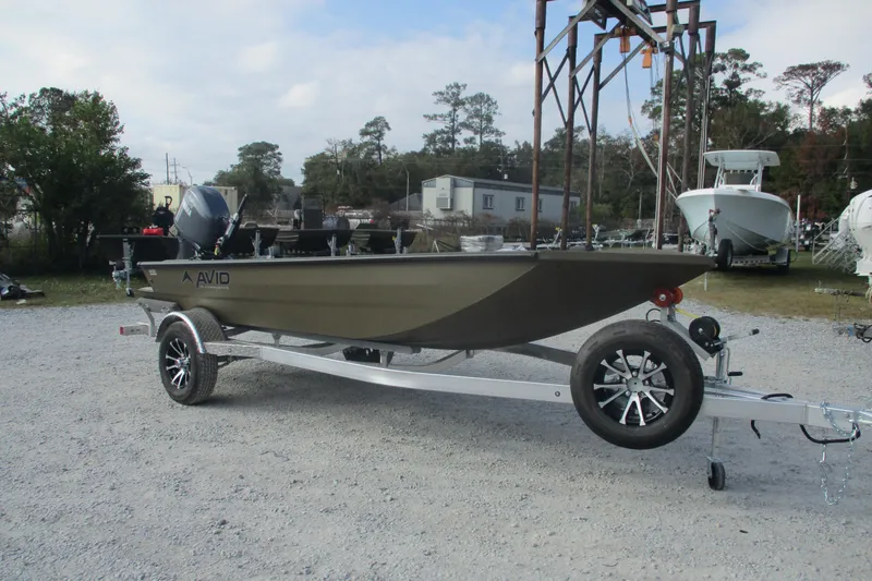 Slide: The Image of 2026 Avid 16 Commander boat on trailer in outdoor setting. - 2